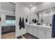 Modern bathroom features a double sink vanity with gray cabinets and a view into the bedroom at 4267 E Highvale Ct, Pahrump, NV 89061