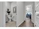 Stylish half-bathroom with a modern sink, toilet, contemporary decorative mirror, and hardwood flooring at 4267 E Highvale Ct, Pahrump, NV 89061