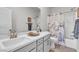 Elegant bathroom featuring a double sink vanity, modern fixtures, and shower with decorative curtain at 4267 E Highvale Ct, Pahrump, NV 89061