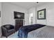 Bright bedroom with an armchair, dresser, TV and blue accents at 4267 E Highvale Ct, Pahrump, NV 89061