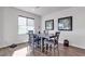 Bright dining area features wood floors, stylish table with seating for four, and modern artwork on the wall at 4267 E Highvale Ct, Pahrump, NV 89061