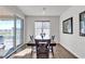 Dining area showcasing a wooden table, a sliding glass door, and a window at 4267 E Highvale Ct, Pahrump, NV 89061