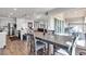 Open concept dining area with stainless steel appliances and modern dining table near sliding glass doors at 4267 E Highvale Ct, Pahrump, NV 89061