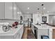 Modern kitchen with stainless steel appliances, center island, and white counter tops at 4267 E Highvale Ct, Pahrump, NV 89061