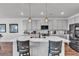 Modern kitchen with large island, stylish pendant lighting and stainless steel appliances at 4267 E Highvale Ct, Pahrump, NV 89061