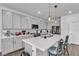 Bright, updated kitchen with white cabinets, an island, pendant lighting, and stainless steel appliances at 4267 E Highvale Ct, Pahrump, NV 89061