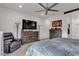 Spacious bedroom featuring a comfortable chair and a dresser with a large television at 4267 E Highvale Ct, Pahrump, NV 89061