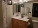 Clean bathroom with wood vanity, single sink, and large mirror at 4537 Buena Vista Dr, Las Vegas, NV 89102