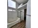 Bathroom featuring a shower, tub, hardwood floors, and lots of natural light at 4610 Cannon Beach St, Las Vegas, NV 89122