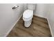 Cozy bathroom with a white toilet and wood-look vinyl flooring at 4610 Cannon Beach St, Las Vegas, NV 89122