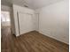 This cozy bedroom features sleek wood floors, a closet, and a door adding practicality to the space at 4610 Cannon Beach St, Las Vegas, NV 89122