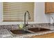 Double basin sink with black faucet and granite countertop at 4793 Cannon Hill Ct, Las Vegas, NV 89130