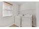 Bright laundry room featuring washer, dryer, and overhead shelving at 4793 Cannon Hill Ct, Las Vegas, NV 89130