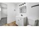 Clean bathroom, featuring a white vanity and marble-tiled shower at 6520 Evergreen Ave, Las Vegas, NV 89107