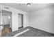 Well-lit bedroom with grey carpet and mirrored closet doors at 6520 Evergreen Ave, Las Vegas, NV 89107