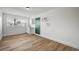 Clean kitchenette with white cabinets, vinyl flooring, and green door at 6520 Evergreen Ave, Las Vegas, NV 89107