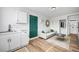 Living room with white cabinets, green door, and light gray sofa at 6520 Evergreen Ave, Las Vegas, NV 89107