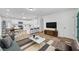 Bright living room with wood floors, stylish furniture, and a modern TV stand at 6520 Evergreen Ave, Las Vegas, NV 89107