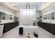 Bright bathroom featuring a soaking tub, dual vanities, stylish lighting, and textured wall at 658 Dragon Peak Dr, Henderson, NV 89012