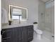 Modern bathroom features a gray vanity with white marble countertop and shower with glass door at 658 Dragon Peak Dr, Henderson, NV 89012