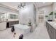 Bright bathroom featuring a soaking tub, dual vanities, and access to a spacious walk-in closet at 658 Dragon Peak Dr, Henderson, NV 89012