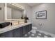 Contemporary bathroom featuring a marble countertop, modern lighting, and stylish wall art at 658 Dragon Peak Dr, Henderson, NV 89012