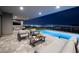 Stylish outdoor patio featuring seating, a pool, and a stunning city skyline view at night at 658 Dragon Peak Dr, Henderson, NV 89012