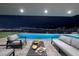 Inviting outdoor space featuring pool, hot tub, and comfortable seating areas with city views in the background at 658 Dragon Peak Dr, Henderson, NV 89012