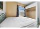 Bedroom with queen bed, wood-look floors, and window at 700 Carnegie St # 4812, Henderson, NV 89052