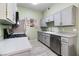 Updated kitchen with gray cabinets, stainless steel appliances and flooring at 700 Carnegie St # 4812, Henderson, NV 89052