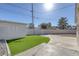 Well-maintained backyard with artificial turf, patio, and a white brick fence ensuring privacy at 704 Berry Cir, Las Vegas, NV 89107