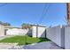 This backyard features artificial grass, a shed and a cinder block wall at 704 Berry Cir, Las Vegas, NV 89107