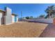 Spacious backyard with gravel and cinder block wall, offering privacy and low maintenance at 704 Berry Cir, Las Vegas, NV 89107