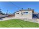 Backyard featuring manicured lawn, concrete pad and perimeter cinder block wall and wood fence at 704 Berry Cir, Las Vegas, NV 89107