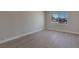 Well-lit bedroom with fresh paint, baseboards, and large window at 704 Berry Cir, Las Vegas, NV 89107