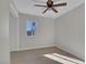 Bedroom with a ceiling fan, a window, and ample closet space for storage at 704 Berry Cir, Las Vegas, NV 89107