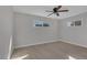 Bright bedroom featuring light wood floors, neutral walls, ceiling fan and double pane windows at 704 Berry Cir, Las Vegas, NV 89107