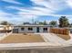 Charming single-story home featuring xeriscaping, fresh exterior paint, and a modern blue front door at 704 Berry Cir, Las Vegas, NV 89107