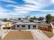 Cozy single-story home with xeriscaping, updated paint, and a contrasting blue front door at 704 Berry Cir, Las Vegas, NV 89107