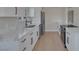 New kitchen featuring modern appliances, quartz counters, white cabinets and long plank flooring at 704 Berry Cir, Las Vegas, NV 89107