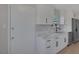 Bright kitchen featuring white cabinetry, stainless steel appliances, and modern quartz countertops at 704 Berry Cir, Las Vegas, NV 89107