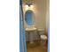 Small bathroom with pedestal sink, toilet, and oval mirror at 7155 Steele Canyon St, Las Vegas, NV 89118