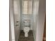 Small half bathroom with toilet and wood-look tile floor at 7155 Steele Canyon St, Las Vegas, NV 89118