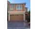 Two-story house with brown exterior, two-car garage, and paved driveway at 7155 Steele Canyon St, Las Vegas, NV 89118