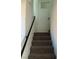 Modern staircase with dark metal railing and carpeted steps at 7155 Steele Canyon St, Las Vegas, NV 89118