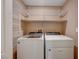 Bright laundry room with washer, dryer, and ample shelving at 752 Golden Sedum Dr, Henderson, NV 89011