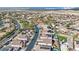 An aerial view shows rows of homes, some with pools, surrounded by desert and powerlines in the distance at 7912 Rushmore Ave, Las Vegas, NV 89131