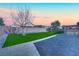 Nice backyard with a paved patio, artificial grass and desert landscaping at 7912 Rushmore Ave, Las Vegas, NV 89131