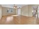 Bright living room with hardwood floors, ceiling fan, neutral paint, and view from large front window at 7912 Rushmore Ave, Las Vegas, NV 89131