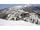 View of a snow covered mountain range with trees along the slopes on a sunny day at 7912 Rushmore Ave, Las Vegas, NV 89131